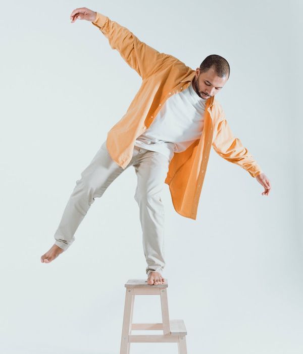 Man performing balance exercise in a modern studio