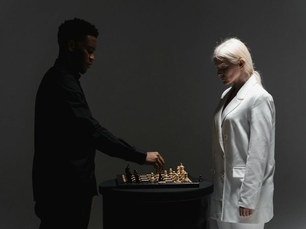 Man standing on a balance board with focused look